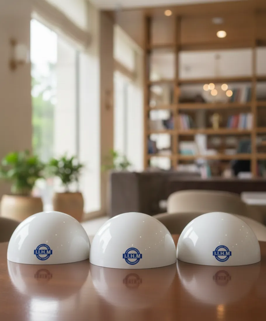 Three opal white domes printed with a logo on a table